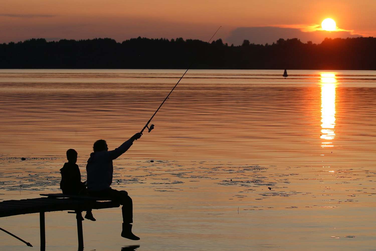 Picutre of Ya man and his son fishing in the sunset